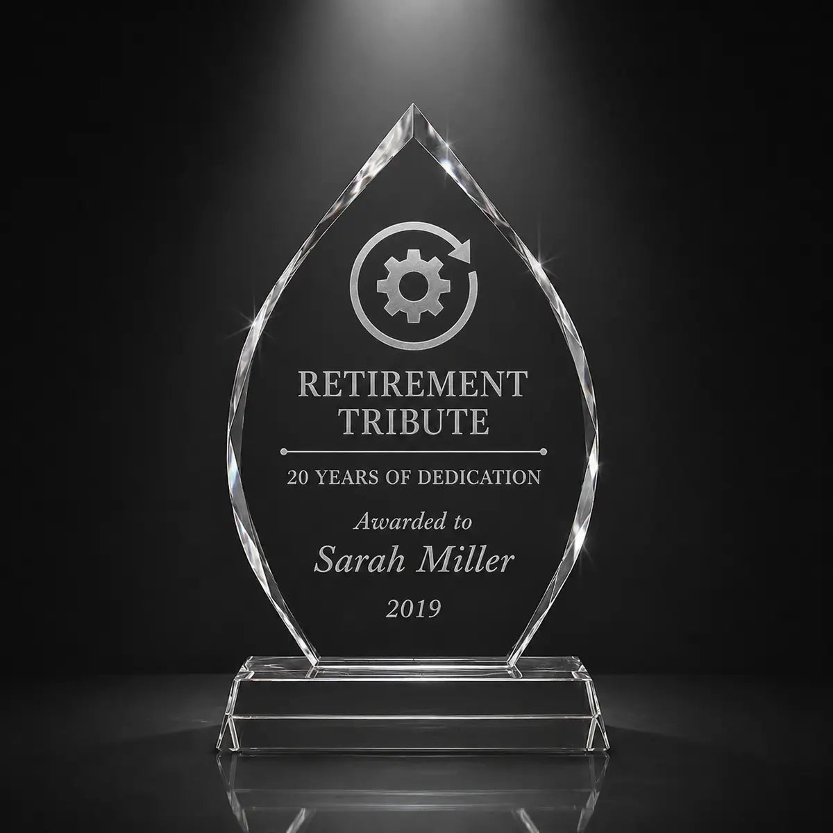 Custom arrowhead crystal retirement tribute award with personalised engraving, clear faceted trophy for employee appreciation, long service and dedication recognition.
