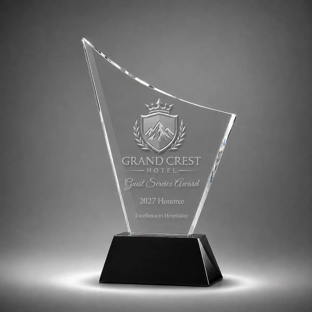 Custom curved crystal guest service award trophy with personalised engraving, clear glass plaque and black base for hospitality recognition, hotel awards and service excellence.