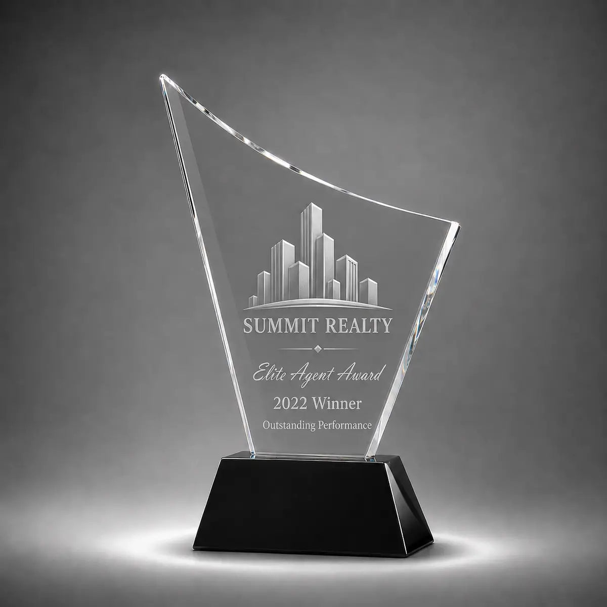 Custom curved crystal real estate agent award trophy with personalised engraving, clear glass plaque and black base for property sales achievement and elite agent recognition.